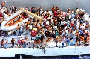 FILE-In this Aug. 24, 1994 file photo, more than one hundred Cuban refugees await to disembark onto a U.S. Naval warship from the Coast Guard Cutter Baronof about 50 miles south of the coast of Key West, Fla.  (AP Photo/Hans Deryk, File)