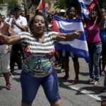 Supporters of the Cuban government shout slogans against the “Ladies in White”, an opposition group in Havana