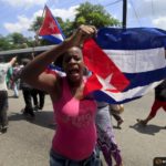 A supporter of the Cuban government shout slogans against the “Ladies in White”, an opossition group in Havana