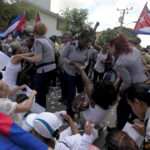 Members of The Ladies in White, an opposition group are detained from Cuban security personnel after their weekly anti-government protest march, in Havana