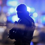 A masked Belgian police officer takes part in police operations in Schaerbeek