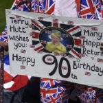 Royal fan Terry Hutt holds a placard as he stands outside of Windsor Castle in Windsor Britain