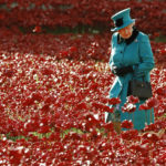 Britain’s Queen Elizabeth walks through a field of ceramic poppies that form part of the art installation “Blood Swept Lands and Seas of Red” at the Tower of London