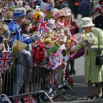 Britain’s Queen Elizabeth receives flowers and cards from well-wishers during a walkabout to celebrate her 90th birthday in Windsor