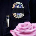 A Dallas Police wears a mourning band as he pays respects at a makeshift memorial at Dallas Police Headquarters following the multiple police shootings in Dallas