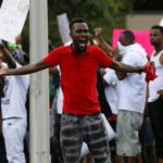 Demonstrators protest the shooting death of Alton Sterling near the headquarters of the Baton Rouge Police Department in Baton Rouge, Louisiana