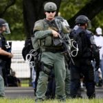 A police officer is seen near the headquarters of the Baton Rouge Police Department in Baton Rouge, Louisiana