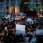 People take part in a protest against police brutality and in support of Black Lives Matter durimg a march in New York