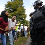 Demonstrators protesting the shooting death of Alton Sterling gather near the headquarters of the Baton Rouge Police department in Baton Rouge, Louisiana