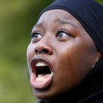 A woman protests the shooting death of Alton Sterling near the headquarters of the Baton Rouge Police Department in Baton Rouge, Louisiana