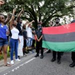 Demonstrators protest the shooting death of Alton Sterling near the headquarters of the Baton Rouge Police Department in Baton Rouge, Louisiana