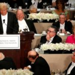Clinton laughs at a joke by Trump at the Alfred E. Smith Memorial Foundation dinner in New York