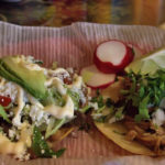Carnitas tacos and the beef tostadas