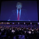 U.S. President Donald Trump is seen on a screen as he delivers remarks at the National Prayer Breakfast in Washington