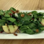 Spinach salad with walnuts, grilled pears and warm bacon dressing