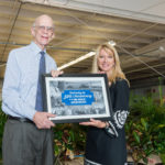 Nancy Botero, Broward College vice president for advancement and executive director of the Broward College Foundation presents a thank you gift to George Weaver, trustee of the Emil Buehler Perpetual Trust