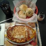 Lasagna, garlic rolls and a soda