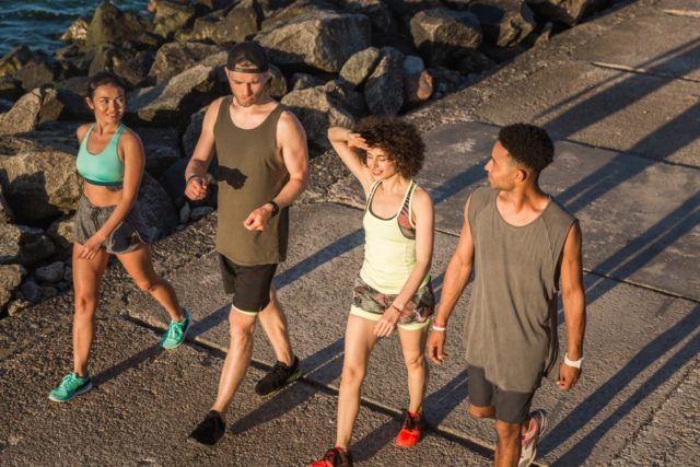 storyblocks-group-of-joggers-talking-and-smiling-during-workout-on-the-beach_BCgBKIhp5Z CDC