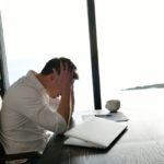 frustrated with problems young business man working on laptop computer at home