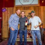 Auction winner Thomas Burkett with Scott Weiselberg and Brian Freed