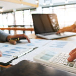 Business executives analysis data document and calculating about fee tax at a office