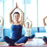 storyblocks/Young woman practicing yoga in yoga class in fitness center