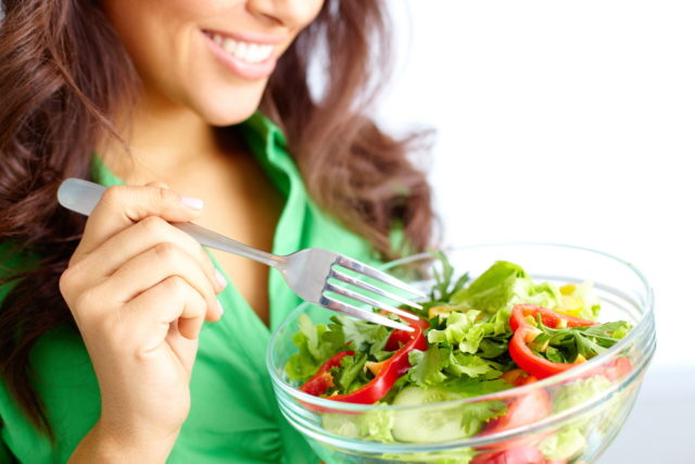storyblocks/Close-up of pretty girl eating fresh vegetable salad