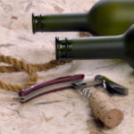 storyblocks/Close up of vine botles and corkscrew on the natural background