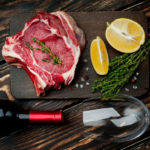 freepik/raw-beef-steak-with-spices-bottle-wine-glass-wood-delicious-dinner_156140-169