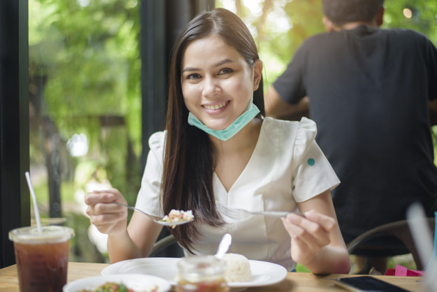 freepik/young woman with face mask is having food in restaurant, New normal concept. https://www.freepik.com/premium-photo/young-woman-with-face-mask-is-having-food-restaurant-new-normal-concept_9102365.htm#page=3&query=mask+restaurant&position=22