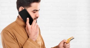 https://www.freepik.com/premium-photo/businessman-keeps-credit-card-talks-mobile-phone_6927216.htm