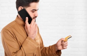 https://www.freepik.com/premium-photo/businessman-keeps-credit-card-talks-mobile-phone_6927216.htm