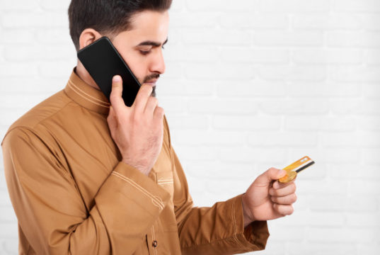 https://www.freepik.com/premium-photo/businessman-keeps-credit-card-talks-mobile-phone_6927216.htm