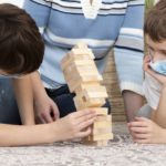 freepik/kids-with-medical-masks-playing-jenga-with-mother_23-2148501343