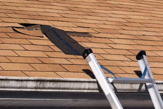 https://www.storyblocks.com/images/stock/fixing-damaged-roof-shingles-a-section-was-blown-off-after-a-storm-with-high-winds-causing-a-potential-leak-bkrxwlrsjiskjlih7