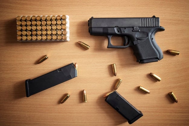 https://www.freepik.com/free-photo/gun-with-box-ammunition-bullets-wooden-wall_11030569.htm#page=1&query=handguns&position=48
