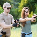 shooting-instructor-teaches-backslider-how-handle-weapon_114354-1092