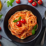 pasta-spaghetti-with-tomato-sauce-black-bowl-top-view_170884-14