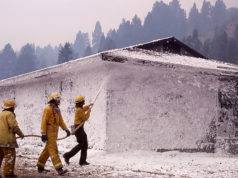 Crew foaming YCC dormitory at Mammoth Hot Springs during 1988 Yellowstone fire, image taken by Jim Peaco, September 10, 1988 and retrieved from the following page [1] of the Yellowstone Digital Slide Files archives which are all in the public domain [2