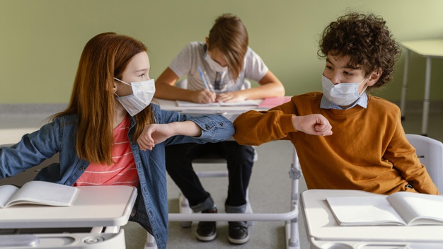 front-view-children-with-medical-masks-doing-elbow-salute-class_23-2148848259 https://www.freepik.com/free-photo/front-view-children-with-medical-masks-doing-elbow-salute-class_12367048.htm