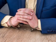 https://www.freepik.com/premium-photo/male-hands-handcuffs-wooden-table_13628382.htm