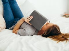 https://www.pexels.com/photo/woman-lying-on-bed-holding-book-1458669/