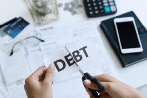 https://www.freepik.com/premium-photo/top-view-woman-hands-cutting-paper-with-word-debt-written-it_7749655.htm#page=1&query=debts&position=46