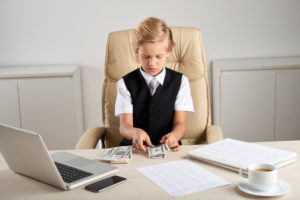 https://www.freepik.com/free-photo/young-caucasian-boy-sitting-executive-chair-office-counting-dollars-desk_5839208.htm#page=2&query=child+money&position=1