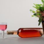 beautiful-bouquet-flowers-bottle-rose-wine-grey-table_114579-39427