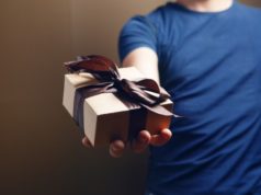 https://www.freepik.com/premium-photo/man-holding-gift-box-his-hand-brown-background_14529448.htm?query=pile%20of%20gifts