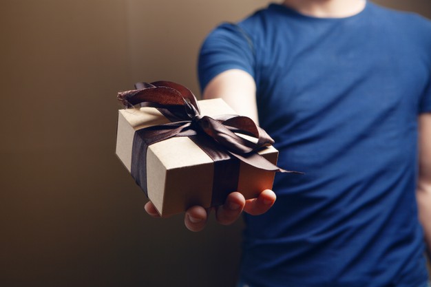 man-holding-gift-box-his-hand-brown-background_438099-2111 https://www.freepik.com/premium-photo/man-holding-gift-box-his-hand-brown-background_14529448.htm?query=pile%20of%20gifts