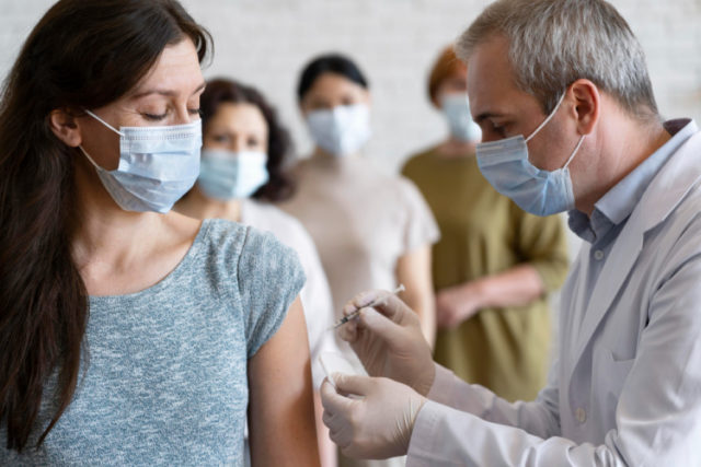 https://www.freepik.com/free-photo/woman-getting-vaccine-shot-by-doctor-with-medical-mask_14833604.htm