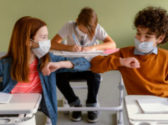 https://www.freepik.com/free-photo/front-view-children-with-medical-masks-doing-elbow-salute-class_12367048.htm?query=covid%20school