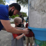 B – A representative from Universal Bear helps Lighthouse client Lucas build his bear